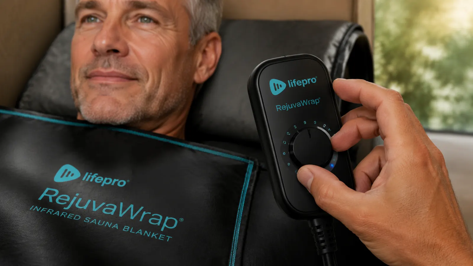 Hand adjusting the temperature dial on an infrared sauna blanket control unit
