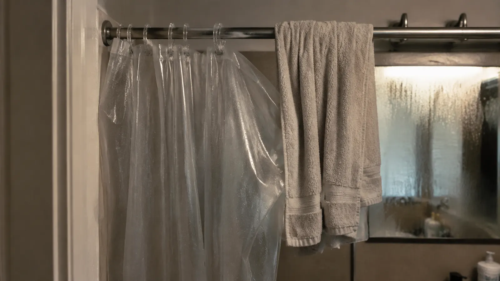 Damp towel and Durasage tent lining hanging over a shower rod to air dry after a session